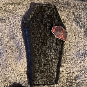 Handmade faux leather coffin wallets with blood splatter print inside.